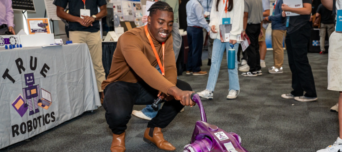 male student interacting with robot